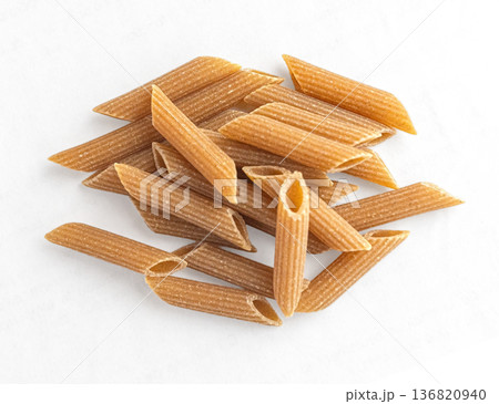 Whole wheat penne pasta pile for healthy meal Whole wheat penne pasta pile for healthy meal 136820940