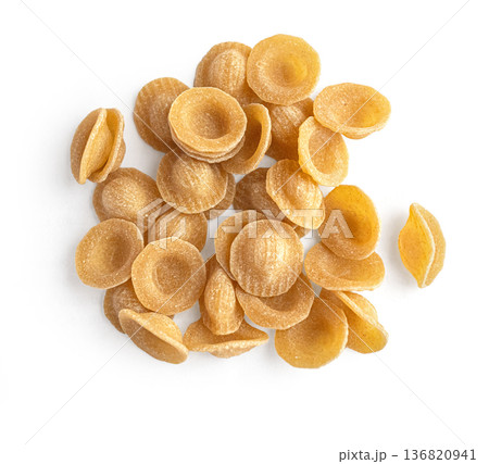 Whole wheat orecchiette pasta heap on white background Whole wheat orecchiette pasta heap on white background 136820941