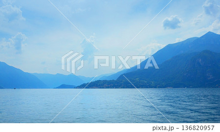 Lake como landscape with distant mountains and blue water 136820957