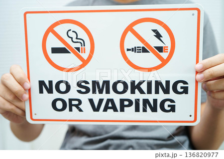 Male holding a no smoking or vaping sign. Male holding a no smoking or vaping sign. 136820977