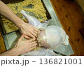 Person stuffing raw turkey Thanksgiving real home kitchen gourmet from scratch food prep 136821001