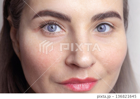 Caucasian woman with blue eyes. One eye with twisted eyelashes (with laminated), the second eye is regular, without cosmetic procedures photo beauty Caucasian woman with blue eyes. One eye with twisted eyelashes (with laminated), the second eye is regular, without cosmetic procedures photo beauty 136821645