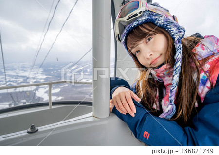 ウィンタースポーツを楽しむために乗り物に乗る若い女性 136821739