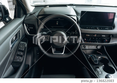 Front panel with steering wheel. Interior of the modern car, close up view Front panel with steering wheel. Interior of the modern car, close up view 136822083