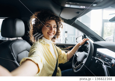 Making a selfie. Happy woman is sitting in the car Making a selfie. Happy woman is sitting in the car 136822168
