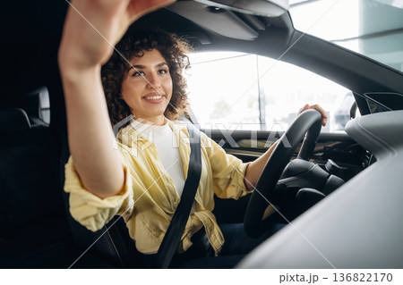 Happy woman is sitting in the car Happy woman is sitting in the car 136822170