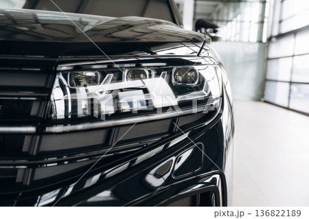 Particle view of modern black car that is parked indoors Particle view of modern black car that is parked indoors 136822189