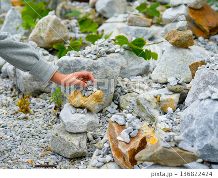 Relaxed spiritually child's hand arrangement pebble tower. Yoga relax meditation Relaxed spiritually child's hand arrangement pebble tower. Yoga relax meditation 136822424