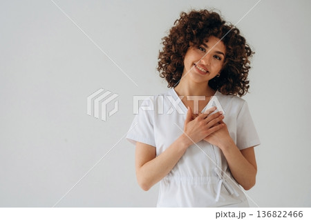 In doctor coat. Beautiful woman is in the studio 136822466