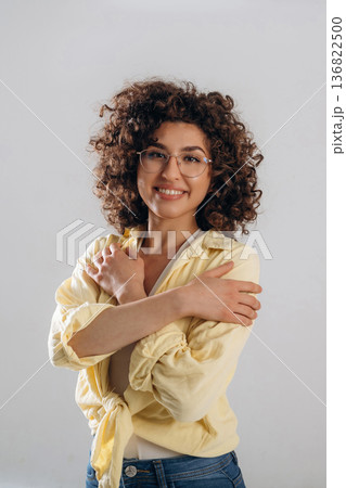 Happy, positive facial expression. Beautiful woman is in the studio 136822500