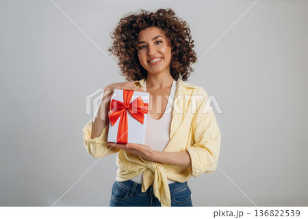 Holidays or birthday conception with gift box. Beautiful woman is in the studio 136822539