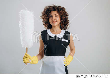 Smiling, conception of cleaning the home. Beautiful woman is in the studio Smiling, conception of cleaning the home. Beautiful woman is in the studio 136822599