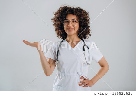 Equipment of stethoscope. Beautiful doctor woman is in the studio 136822626