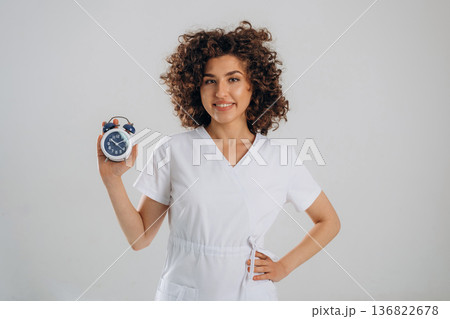 Clock, the time is ticking. Beautiful woman is in the studio 136822678