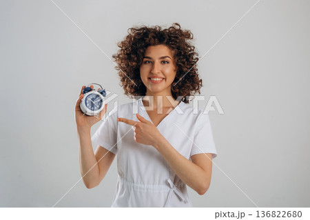 Clock, the time is ticking. Beautiful woman is in the studio 136822680