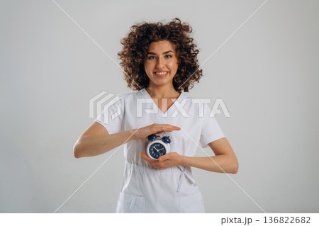 Clock, the time is ticking. Beautiful woman is in the studio Clock, the time is ticking. Beautiful woman is in the studio 136822682