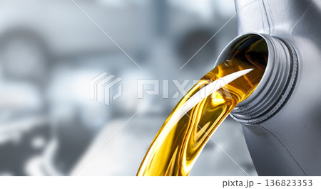 Pouring motor oil into the car engine 136823353
