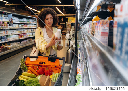 Gorgeous woman is in the grocery store 136823563