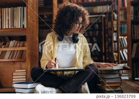 Beautiful woman is in the library Beautiful woman is in the library 136823709