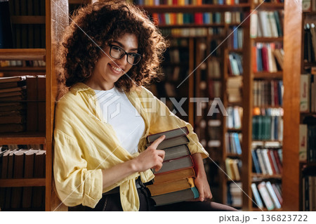 Beautiful woman is in the library 136823722