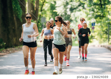 Marathon conception, front view. Group of runners are together outdoors 136824089