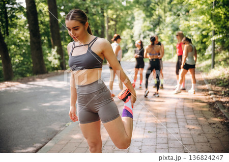 Getting ready, standing. Group of runners are together outdoors Getting ready, standing. Group of runners are together outdoors 136824247