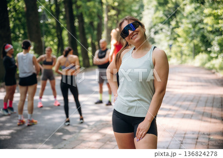 Eyewear, sunny weather. Group of runners are together outdoors Eyewear, sunny weather. Group of runners are together outdoors 136824278
