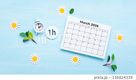 Daylight saving Time, Spring forward, Summer back concept. White Alarm Clock and Spring Daisy Flowers on Blue Background 136824339