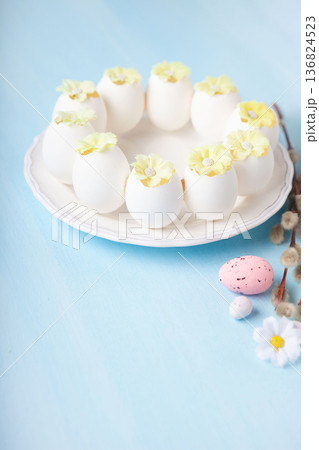 Easter spring  holiday card. Playful bunny, painted eggs, willow branches, spring flowers, decorative elements on light blue background 136824523