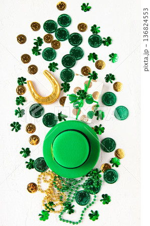 Top view flat lay for Saint Patrick's Day holiday with green objects, shamrock symbols, and copy space. For banners, posters, greetings, seasonal marketing, and holiday background design. 136824553