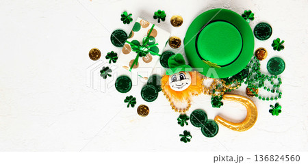 Top view flat lay for Saint Patrick's Day holiday with green objects, shamrock symbols, and copy space. For banners, posters, greetings, seasonal marketing, and holiday background design. Top view flat lay for Saint Patrick's Day holiday with green objects, shamrock symbols, and copy space. For banners, posters, greetings, seasonal marketing, and holiday background design. 136824560