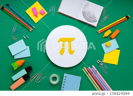 Happy World Pi Day concept. March 14th (3/14). Educational Pi Day flat lay with mathematical message, stationery arrangement, green background, 136824894