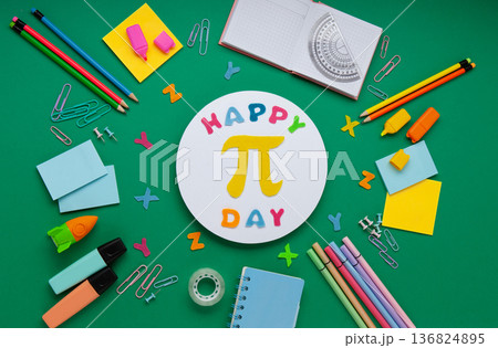 Happy World Pi Day concept. March 14th (3/14). Educational Pi Day flat lay with mathematical message, stationery arrangement, green background, 136824895