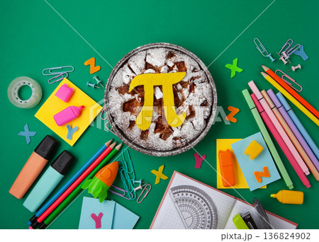 World Pi day. Baked apple pie with Pi Symbol and stationery, green background.   March 14th (3/14). Mathematical constant. 136824902