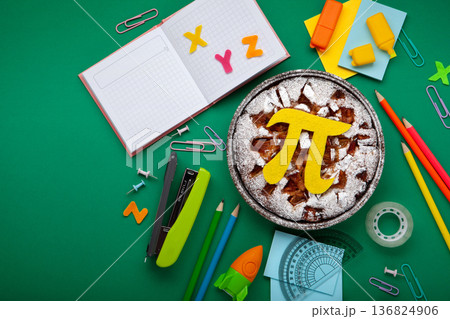 World Pi day. Baked apple pie with Pi Symbol and stationery, green background.   March 14th (3/14). Mathematical constant. 136824906