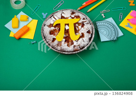 World Pi day. Baked apple pie with Pi Symbol and stationery, green background.   March 14th (3/14). Mathematical constant. 136824908