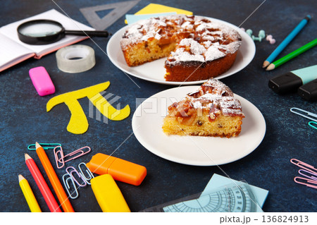 International World Pi day. Baked apple pie with Pi Symbol and stationery, dark blue background. March 14th 3,14. Mathematical constant. International World Pi day. Baked apple pie with Pi Symbol and stationery, dark blue background. March 14th 3,14. Mathematical constant. 136824913