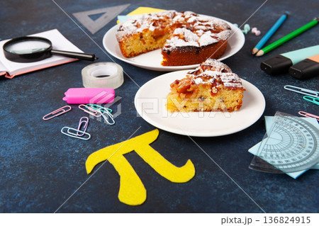 World Pi day. Baked apple pie with Pi Symbol and stationery, dark blue background. March 14th 3.14. Mathematical constant. World Pi day. Baked apple pie with Pi Symbol and stationery, dark blue background. March 14th 3.14. Mathematical constant. 136824915
