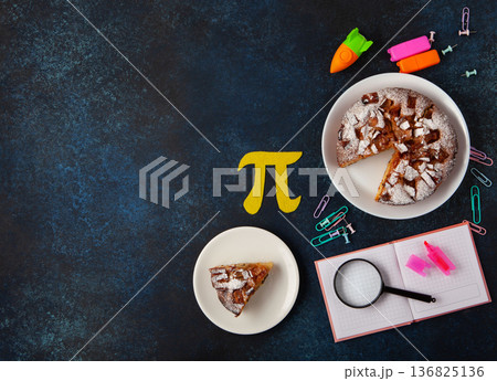 World Pi day. Baked apple pie with Pi Symbol and stationery, dark blue background. March 14th 3.14. Mathematical constant. World Pi day. Baked apple pie with Pi Symbol and stationery, dark blue background. March 14th 3.14. Mathematical constant. 136825136