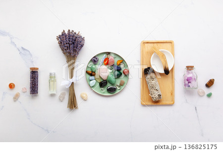 Chakra Crystal Healing Ritual With Lavender Palo Santo White Sage Essential Oils And Candles On White Marble Background 136825175