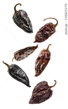 Dried chili peppers scattered and isolated on white background, spicy food concept, showcasing culinary ingredients texture Dried chili peppers scattered and isolated on white background, spicy food concept, showcasing culinary ingredients texture 136825279