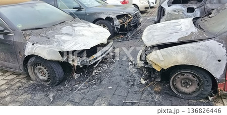 Burned and severely damaged cars parked in a lot after a fire incident. Burned and severely damaged cars parked in a lot after a fire incident. 136826446