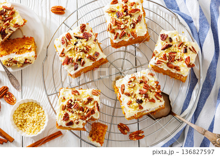 Carrot cake squares with cream cheese and pecan 136827597