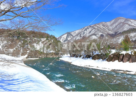 【岐阜県】快晴の庄川の雪景色（白川郷） 136827603
