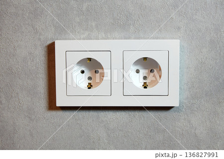 Electrical outlets are neatly arranged on a gray wall in a modern interior Electrical outlets are neatly arranged on a gray wall in a modern interior 136827991