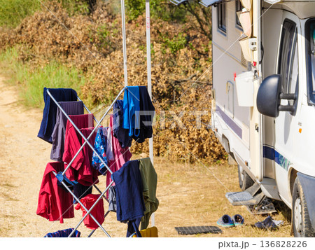Clothes hanging to dry outdoors by camping car. Caravan vacation. 136828226