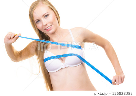 Girl measuring her chest breasts bust size Girl measuring her chest breasts bust size 136828385