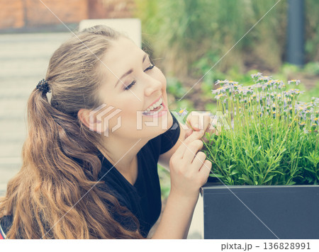 Woman smelling flowers Woman smelling flowers 136828991