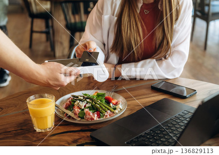 Wireless payment by using smartphone. Woman n the cafe restaurant 136829113