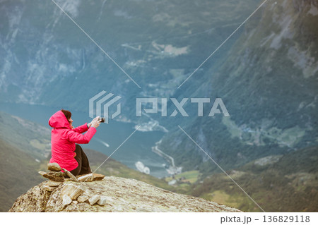 Tourist taking photo from Dalsnibba viewpoint Norway Tourist taking photo from Dalsnibba viewpoint Norway 136829118